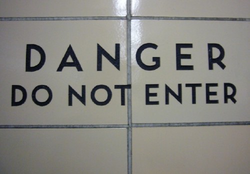 Two-line sign reads DANGER DO NOT ENTER with different spacings