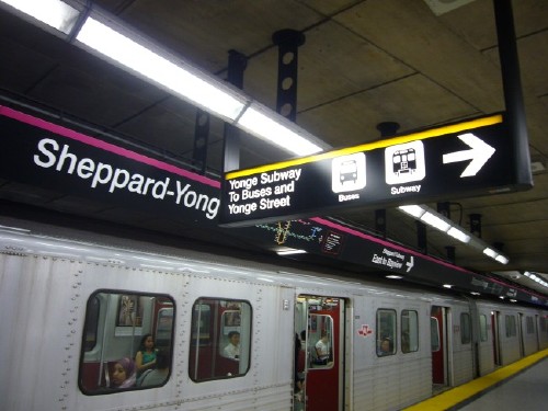 Sign running orthogonally from Sheppard-Yonge signband reads Yonge Subway To Buses and Yonge Street