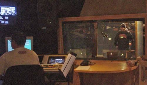 Two solitudes in the studio and booth Richard works the controls while Jeremy stands visible through a window in his soundproof booth