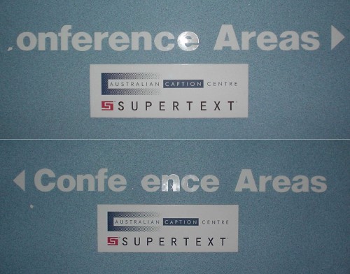 (Composite photo) Signs read “onference Areas ▶” and “◀ Confe ence Areas” over Australian Caption Centre Supertext insignia