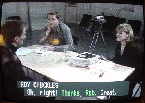 Caption in white reads ROY CHUCKLES atop three short sentences in two colours on one line
