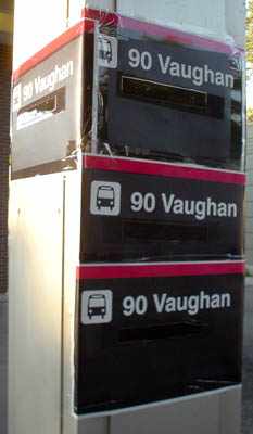 Pole is festooned with four taped-up copies of a sign reading 90 Vaughan