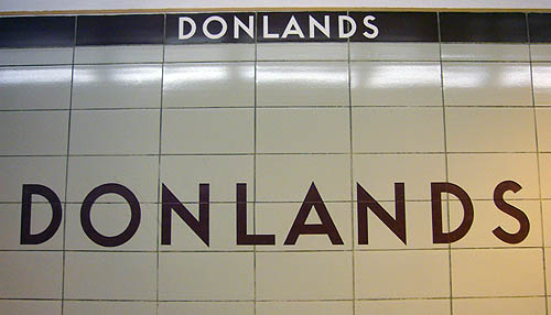 Tiled wall reads DONLANDS in widely-spaced brown letters and, at top, DONLANDS In white on a brown stripe