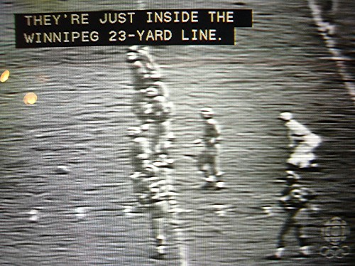 Black-and-white football game with two lines of captions