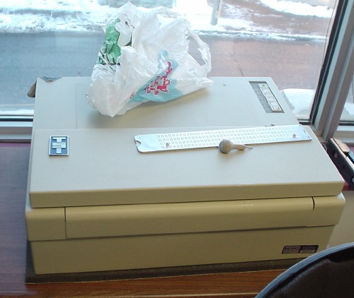 Printer, with closed lid, carries TSI logo