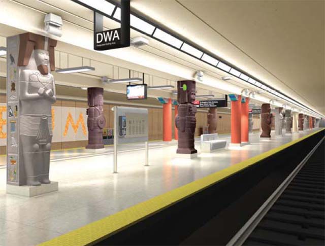 Subway station has hanging light fixtures, hanging signs, a hanging video screen, an infomration plaque, and columns dressed up as mummies