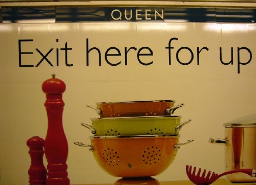 Strapline reads QUEEN above a photo of a colander and a crewet set and a headline: Exit here for up