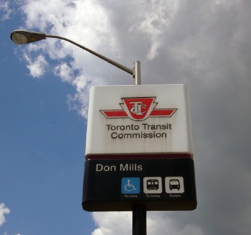 Sign against partly-cloudy sky uses ‘Helvetica’ and reads Toronto Transit Commission Don Mills