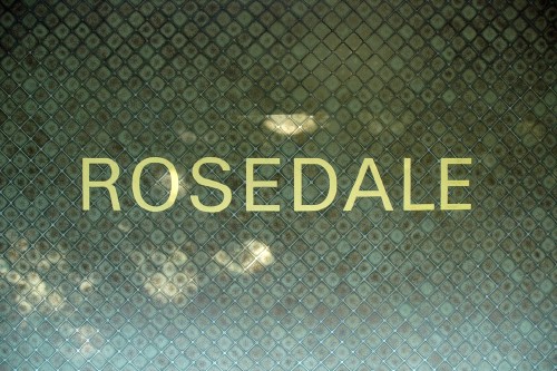 Green tiles with criscrossing pattern have ROSEDALE inscribed in yellow Univers