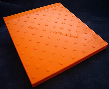 Orange CD case with round bumps and Pet Shop Boys VERY written diagonally across the front in Helvetica