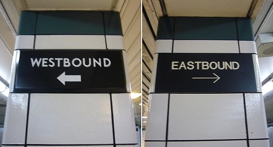 Two columns have signs reading WESTBOUND ← and EASTBOUND → in different fonts