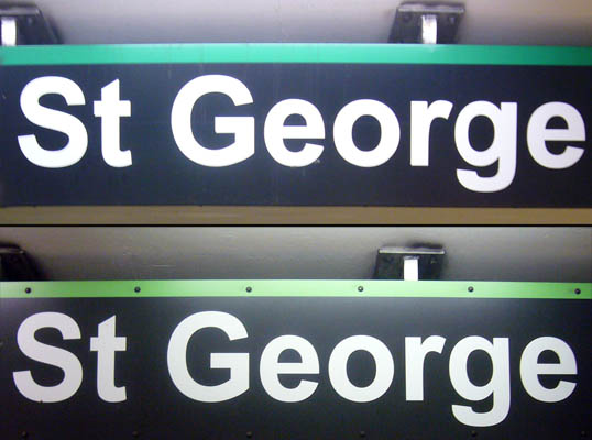 Two signs with green lines along the top reading St George in white type on black