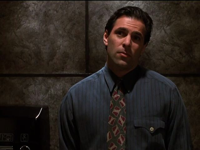 Michael standing before mottled wall panelling