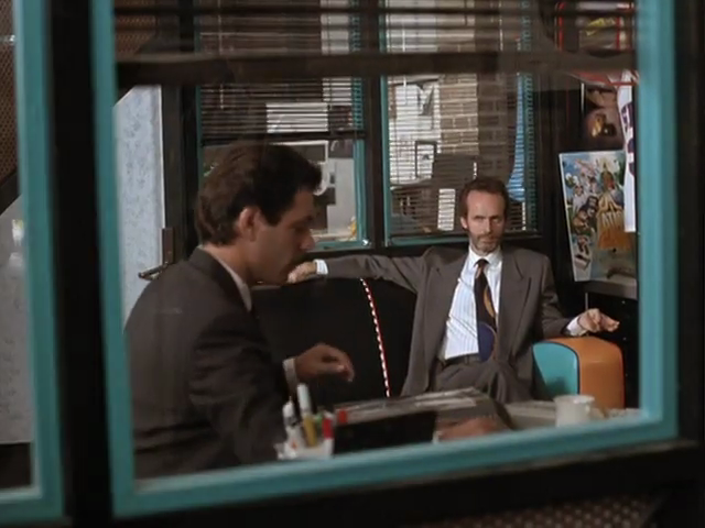 Michael and Miles seen through interior window, with teal borders