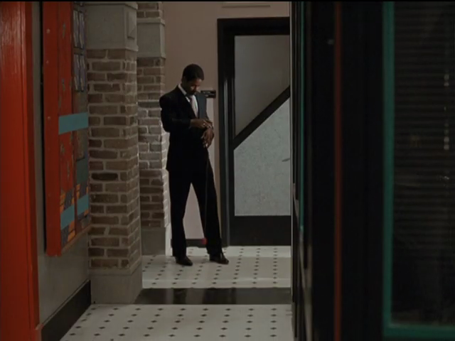 Brick exterior walls, black inside walls with orange and teal piping; bright orange door jamb with matching nearby painting