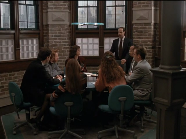 Conference room with brick walls, glass-brick windows at bottom half of panes