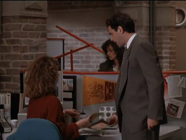 Brick walls, orange partition-wall tops, angled orange sculpture akin to a Tizio lamp