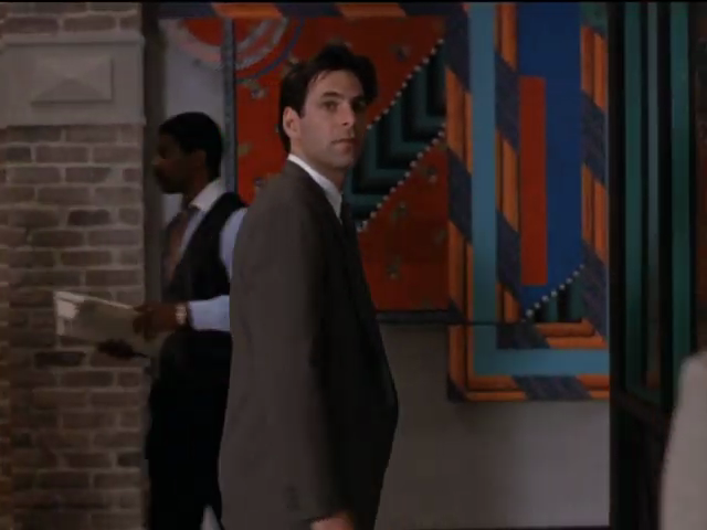 Michael in front of orange artwork on wall