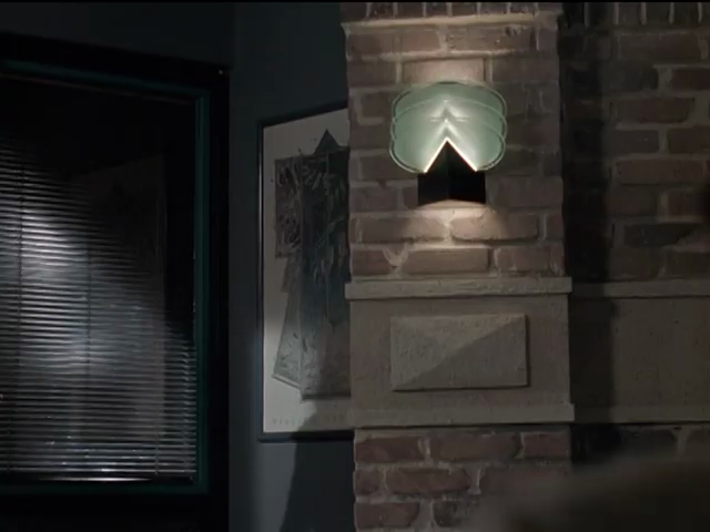 Exposed-brick wall; green wall sconce