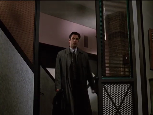 Michael walking through doorway with angled panelling, mesh