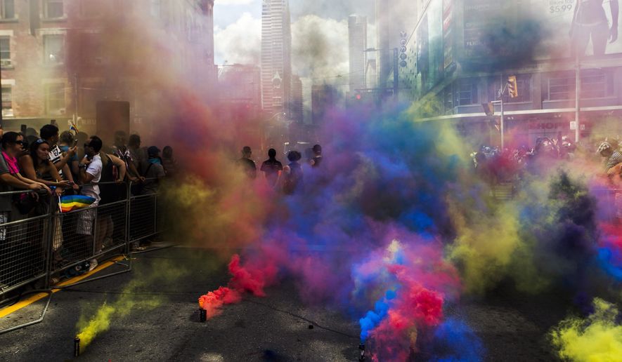 Multicoloured smoke bombs obscure almost all the view of a street